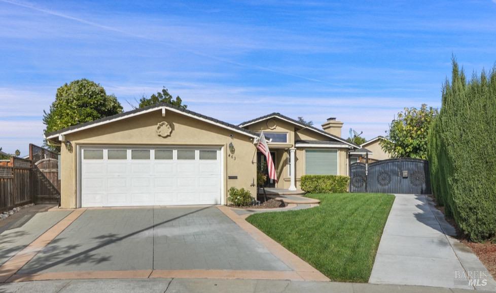 a front view of a house with a yard and garage