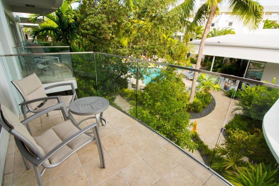 a balcony with table and chairs