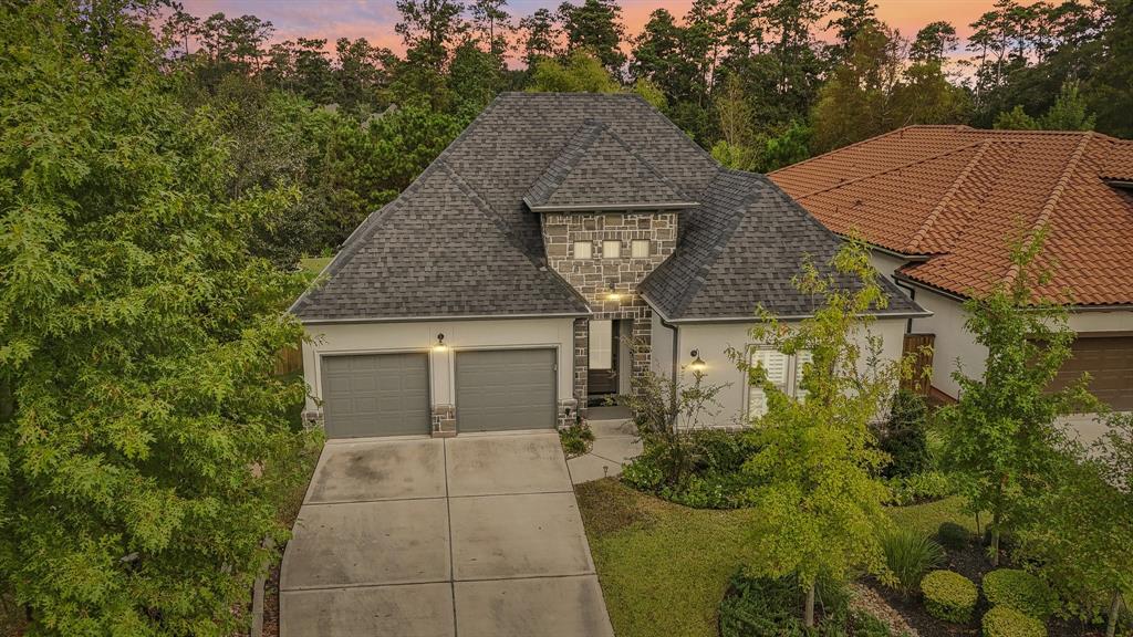 a aerial view of a house with yard and trees