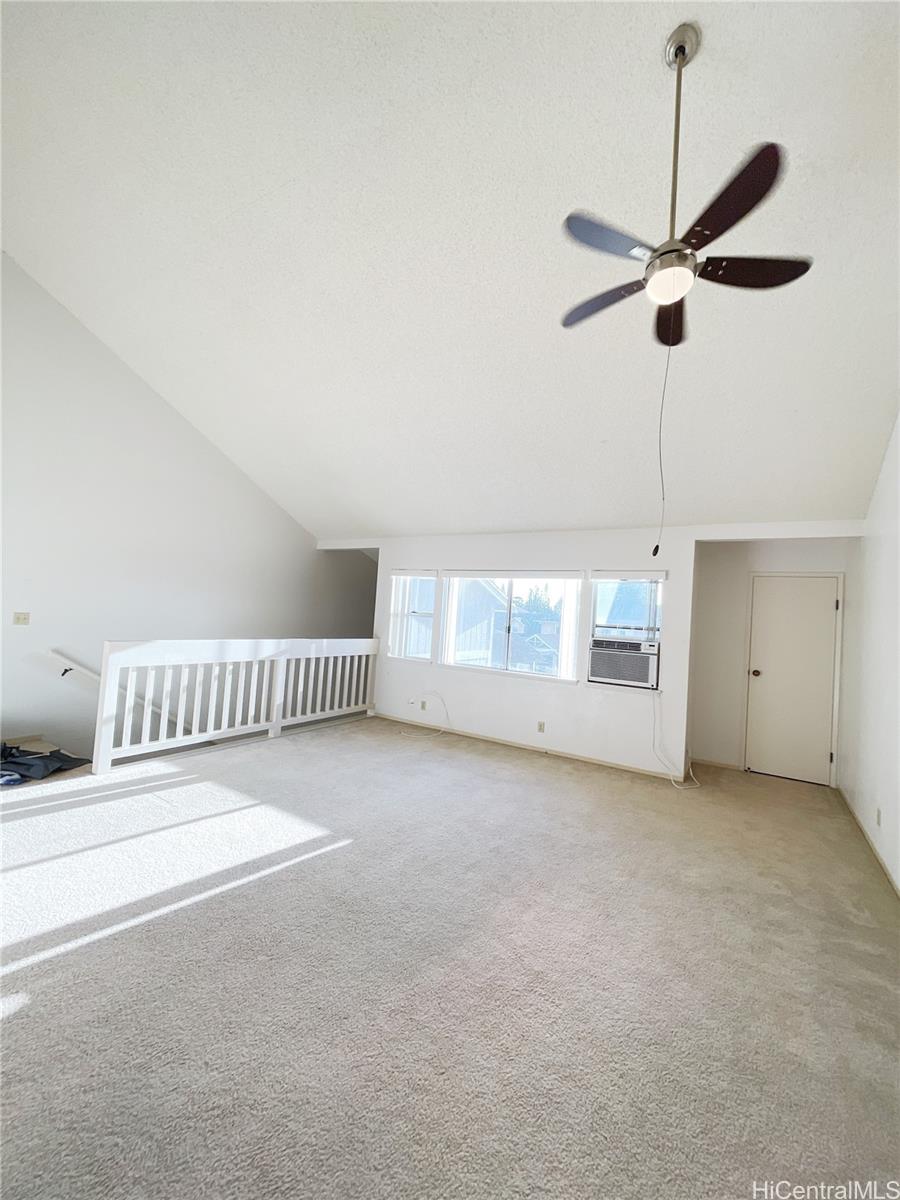 a view of a livingroom with a ceiling fan and window