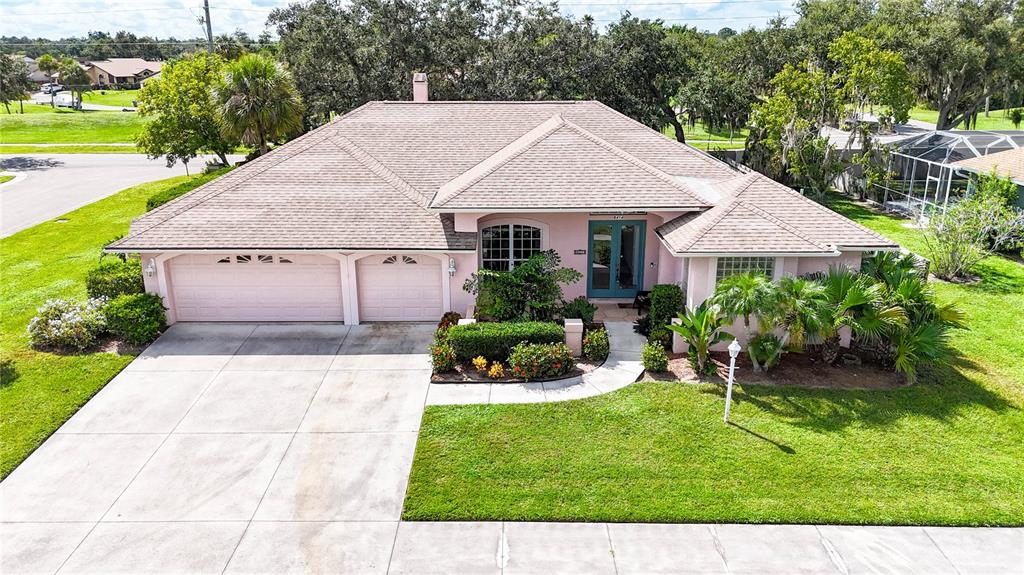 a aerial view of a house with garden and a yard