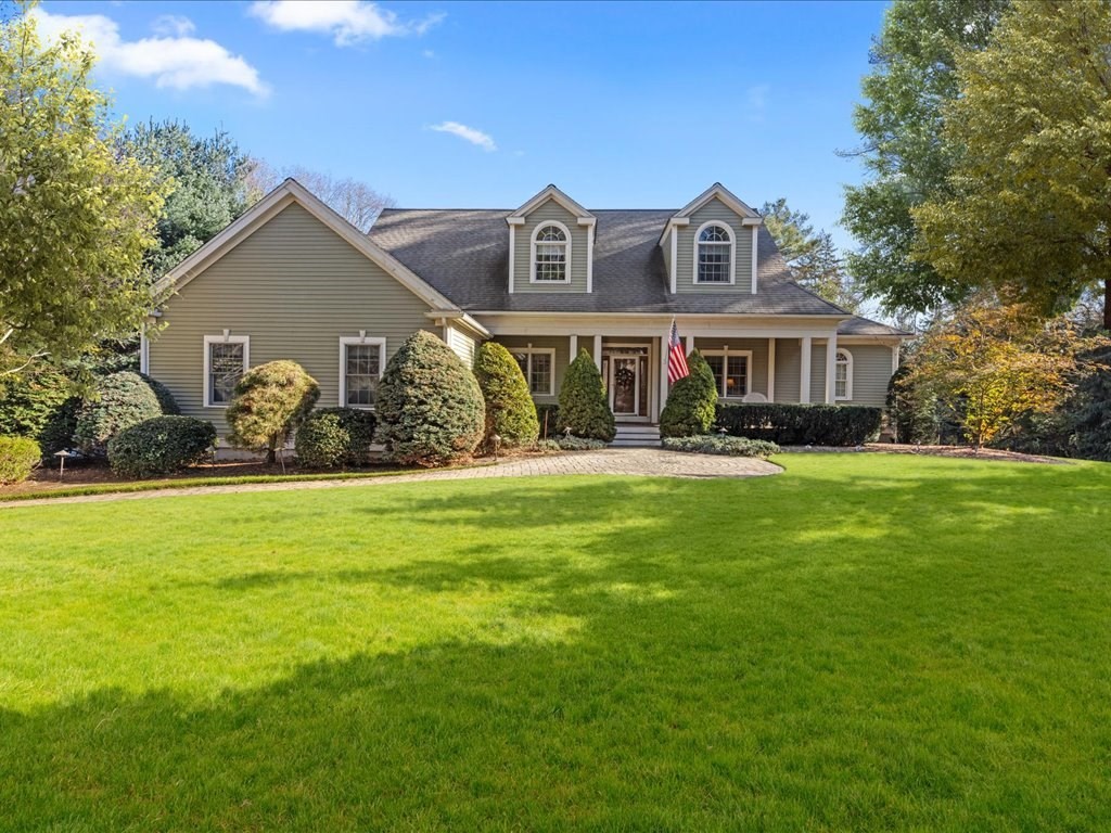 a front view of house with yard and green space