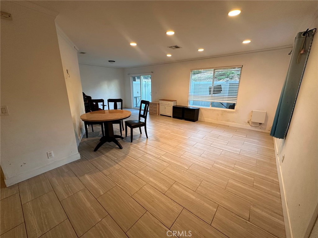 a view of a work space with wooden floor and furniture