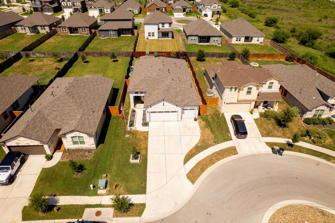 an aerial view of residential houses with outdoor space