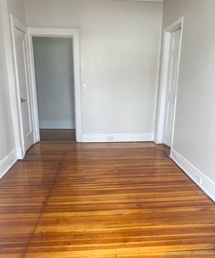 a view of a room with wooden floor