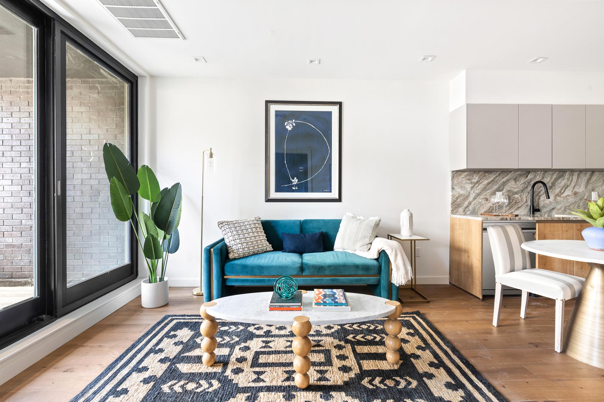 a living room with furniture and a potted plant