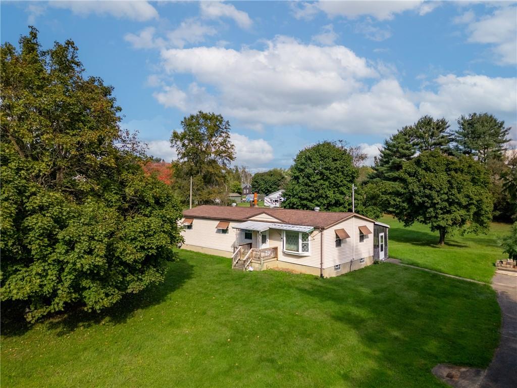 Experience the perfect blend of rustic charm and cozy living in this manufactured ranch home, a perfect complement to the natural beauty of its nearly 2- acre setting.