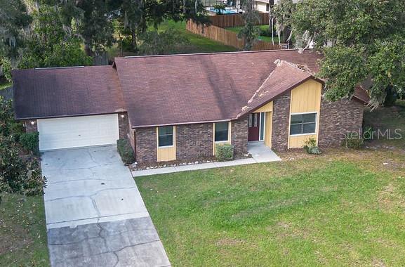 a aerial view of a house with a yard and a garage