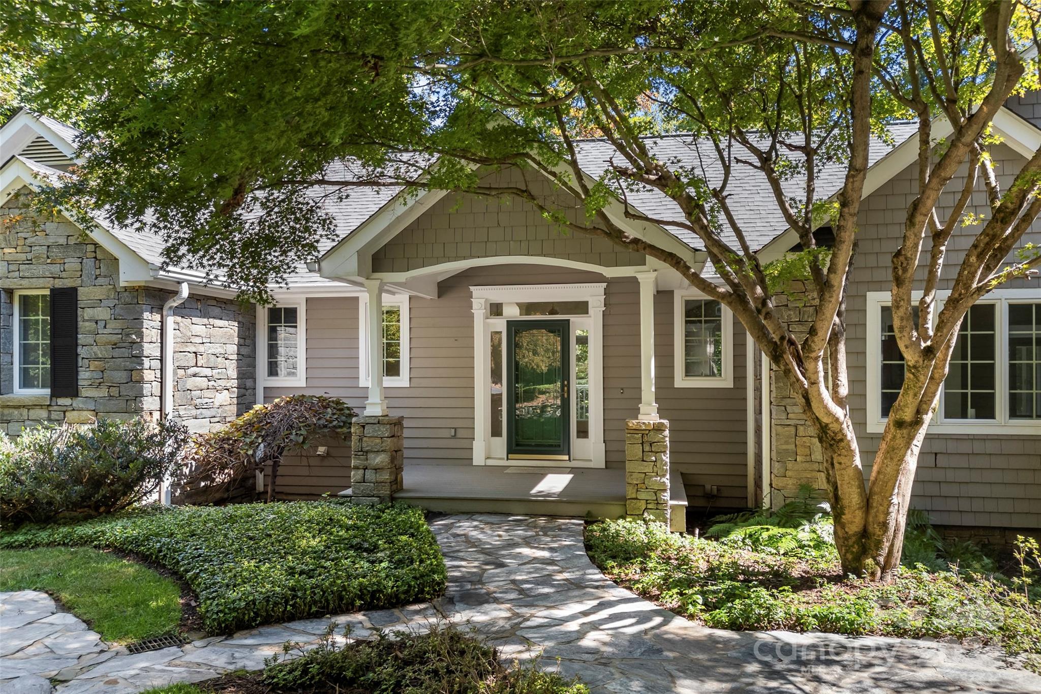 a front view of a house with garden