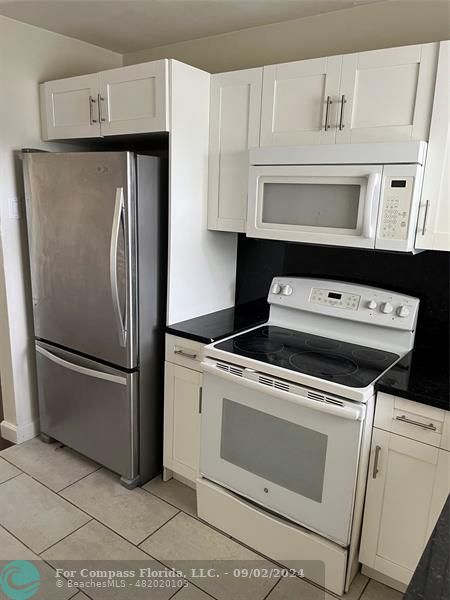 a close view of a stove top oven and refrigerator