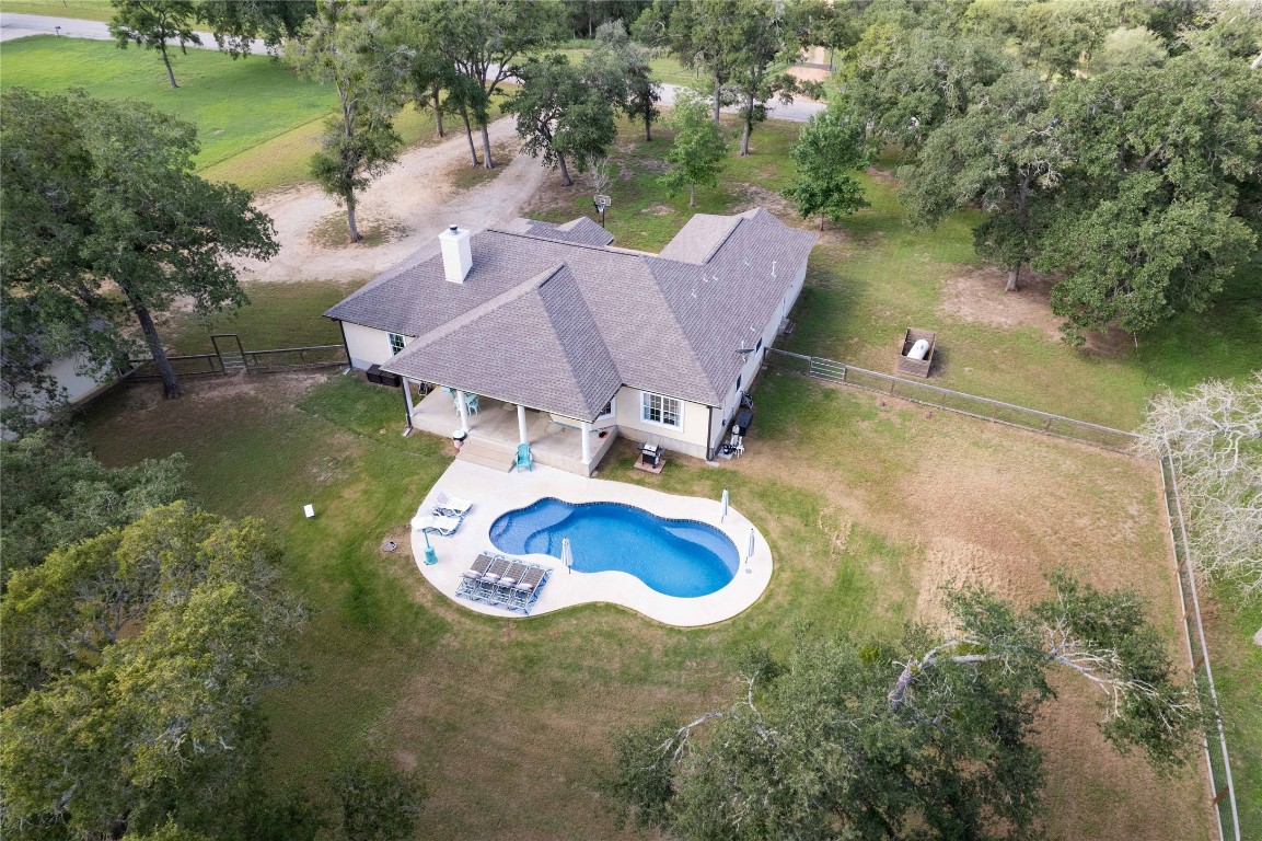 a aerial view of a house with swimming pool and lake view