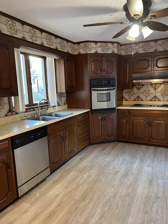 a kitchen with stainless steel appliances granite countertop a sink and cabinets