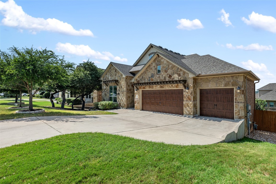 a front view of a house with a garden and yard