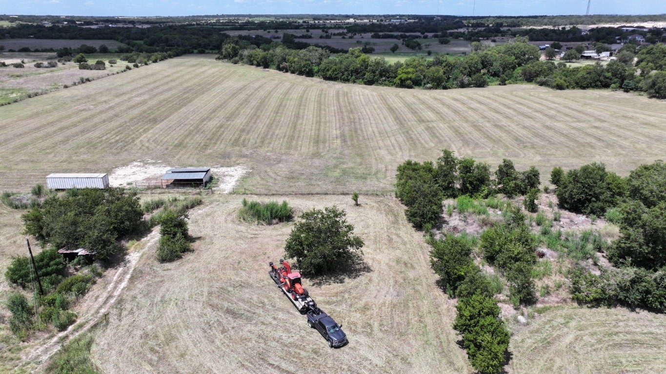 an aerial view of a house with a yard