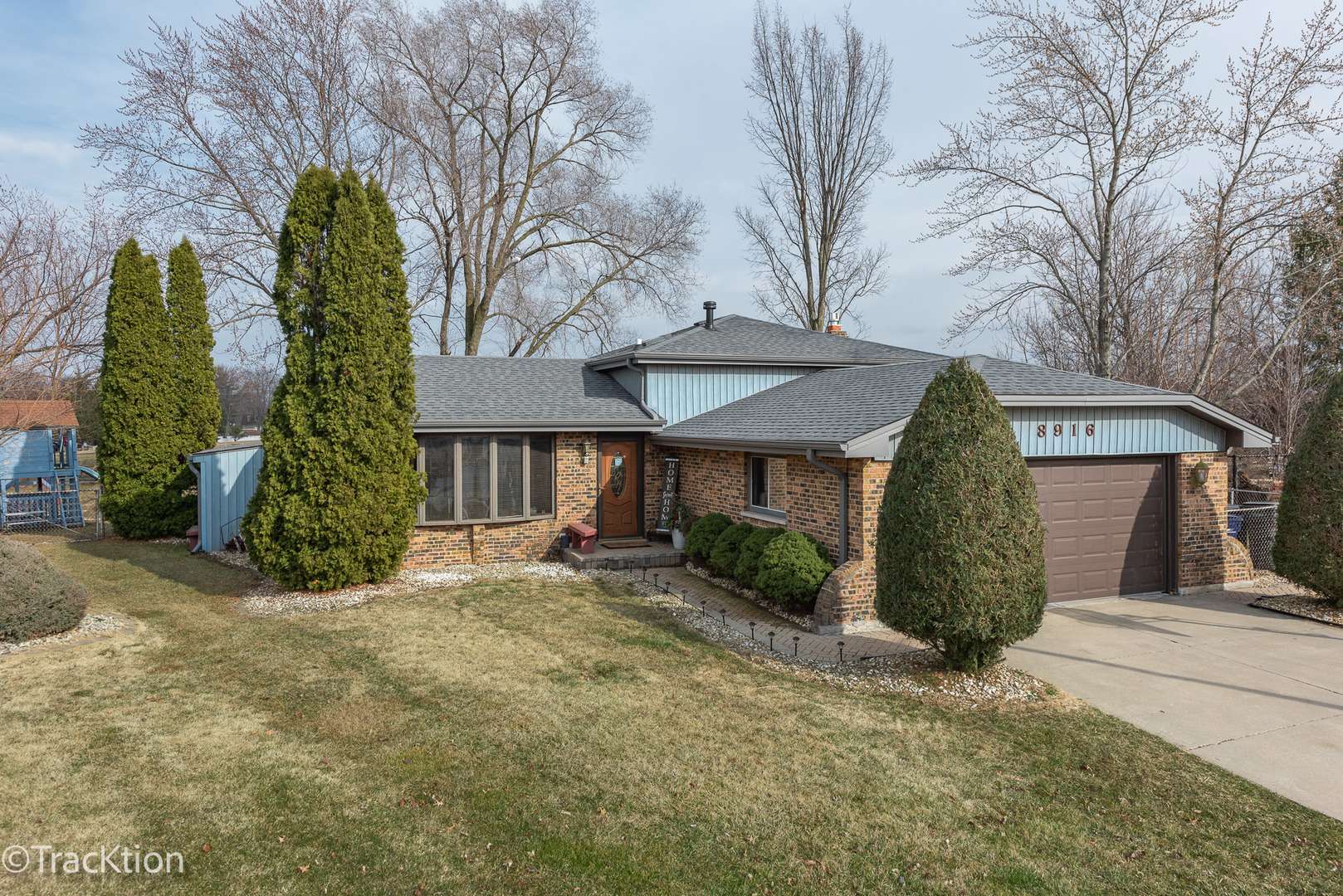 a view of a house with a yard and garage