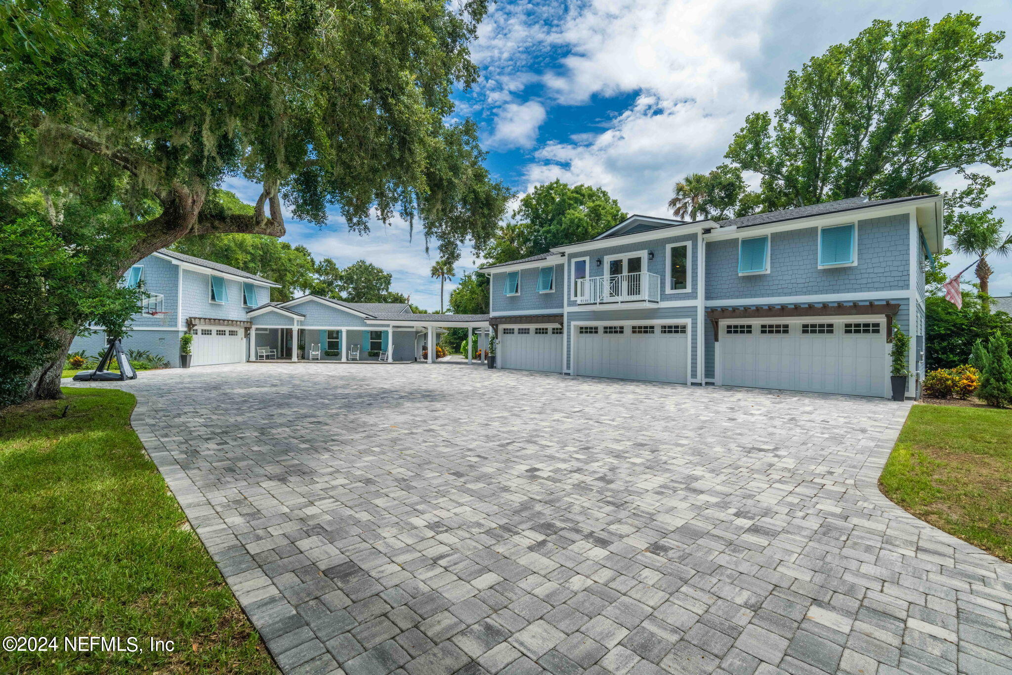 a front view of house with yard and trees in the background