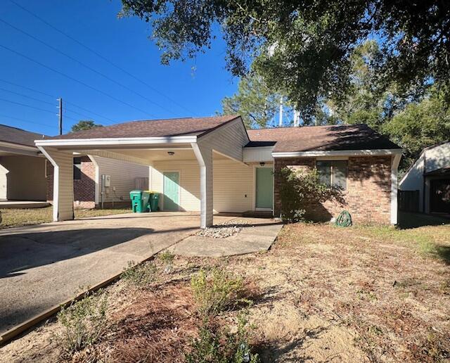 a view of a house with a tree in the yard