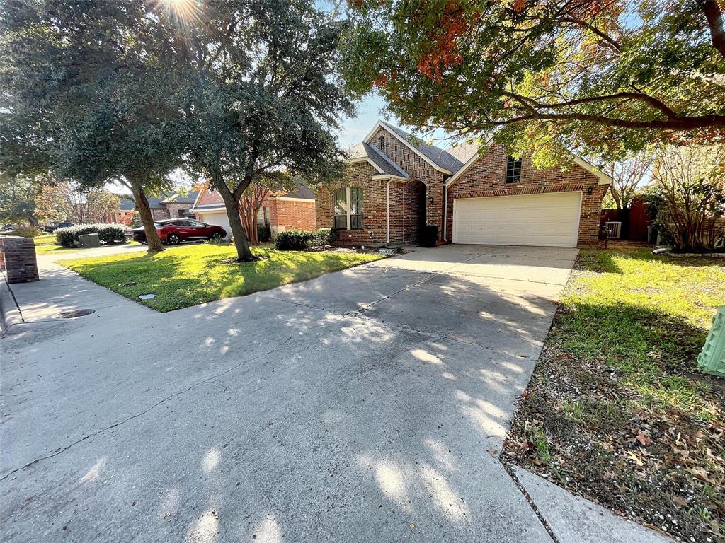 a front view of a house with a yard and a garage