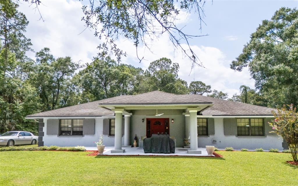 a front view of house with yard patio and swimming pool