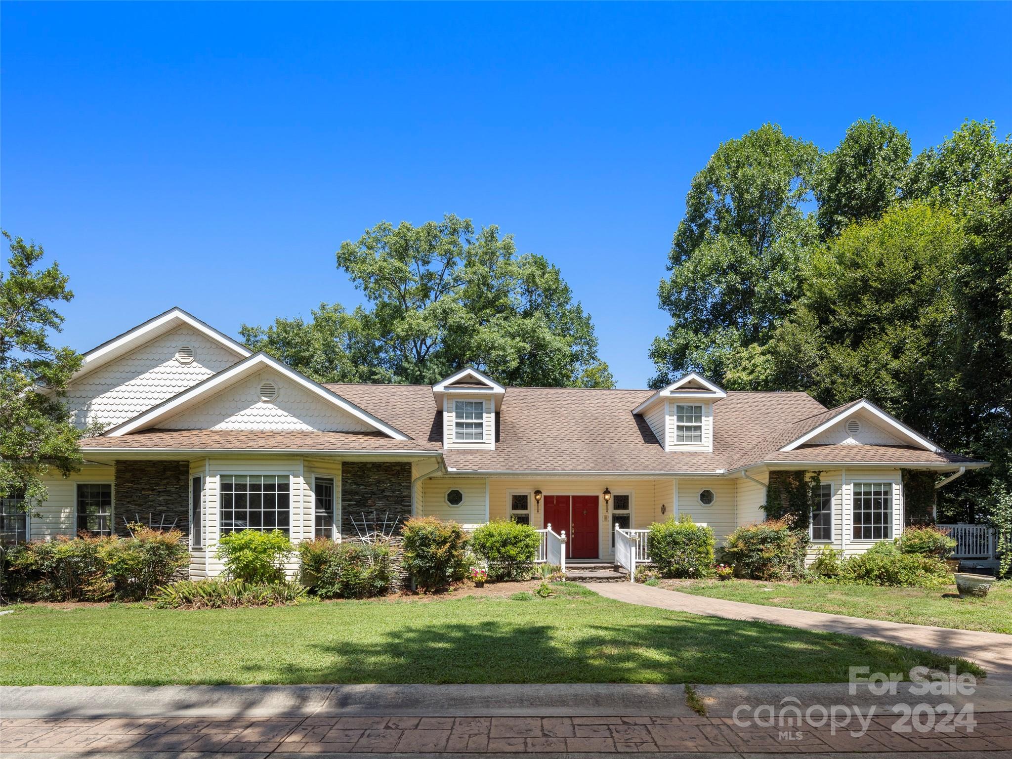 a front view of a house with a garden