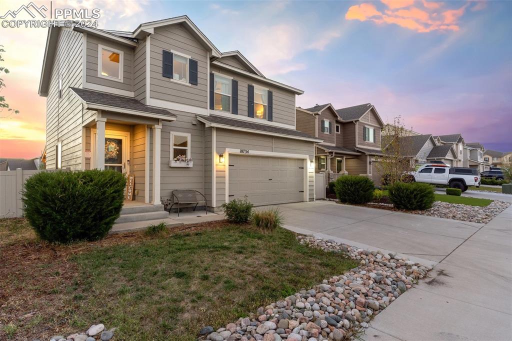 a front view of a house with a yard and garage