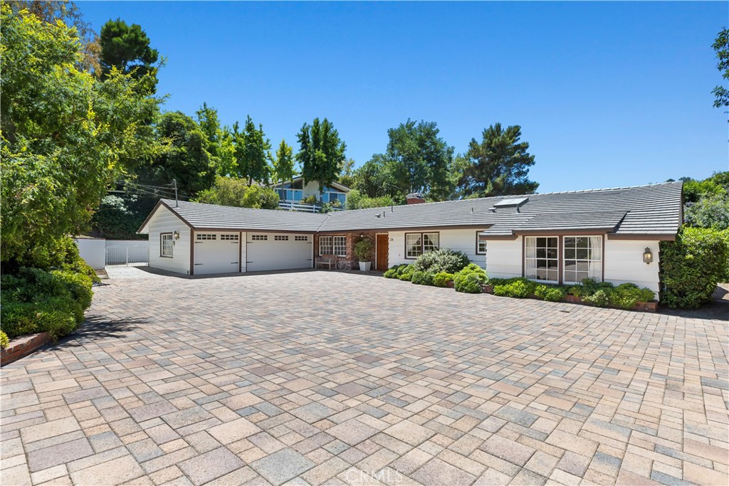 a front view of a house with a yard and a garage