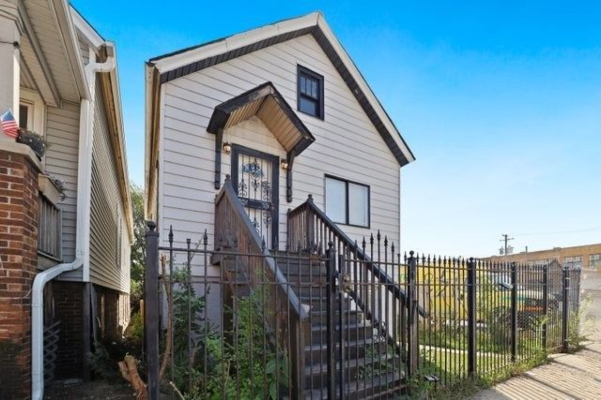 a view of a house with iron fence