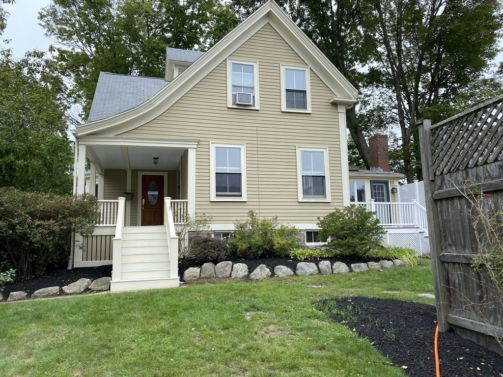 a view of a house with a yard and plants