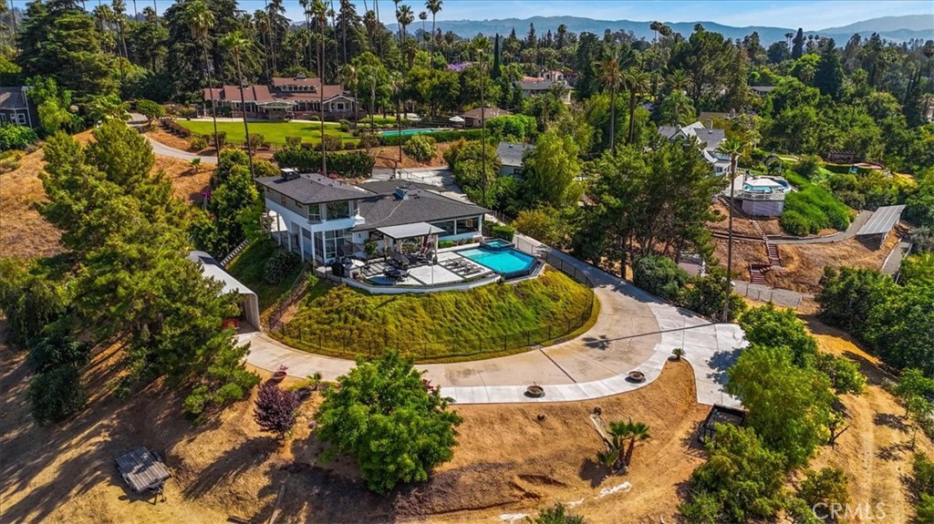 an aerial view of a house with yard swimming pool and outdoor seating