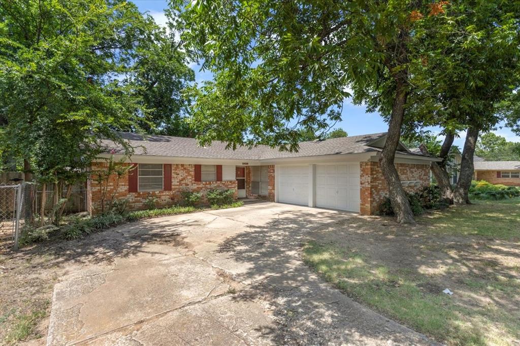 a view of a yard with a house and a tree