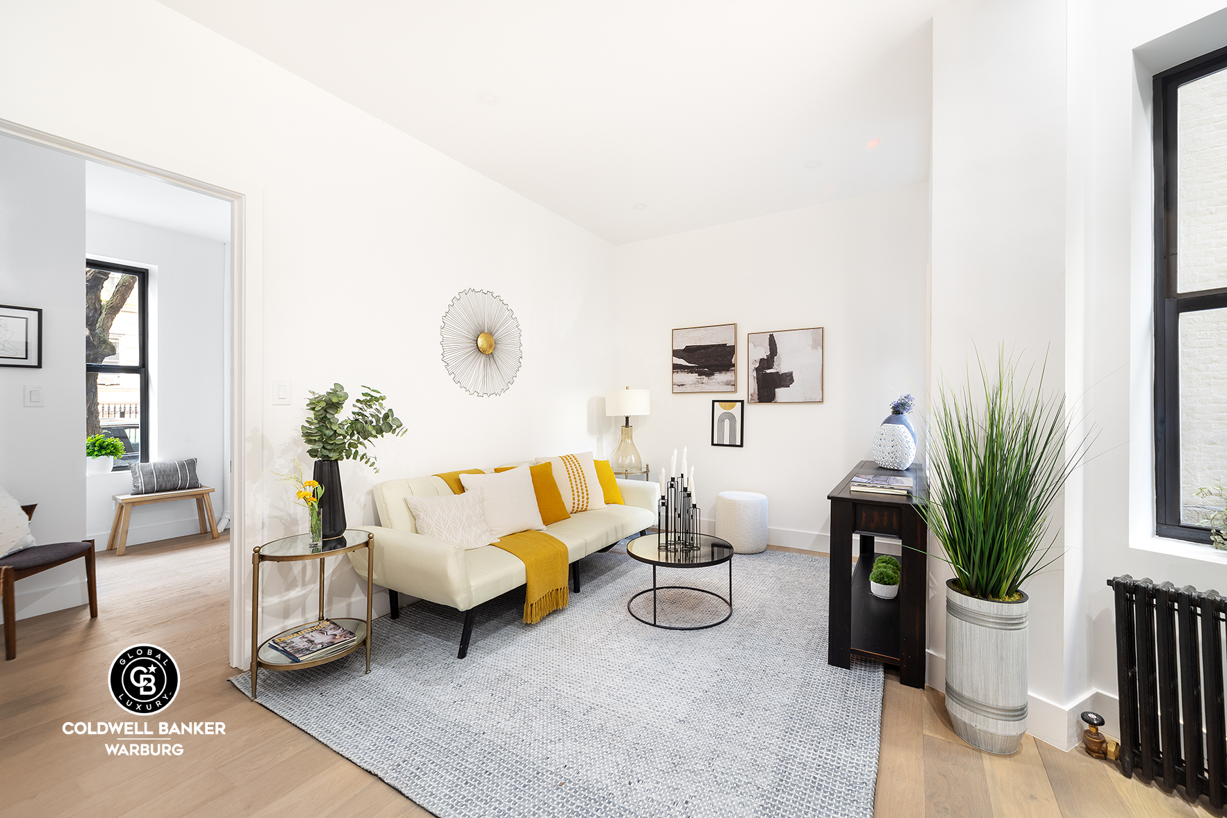 a living room with furniture and a potted plant