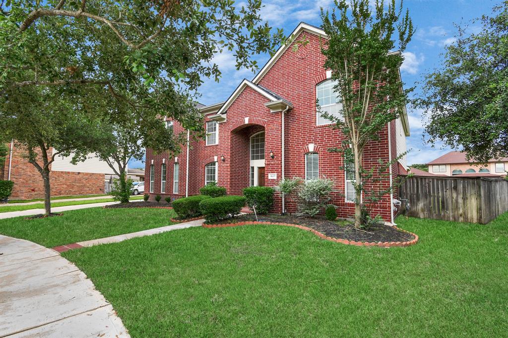 a front view of a house with a yard garage and outdoor seating