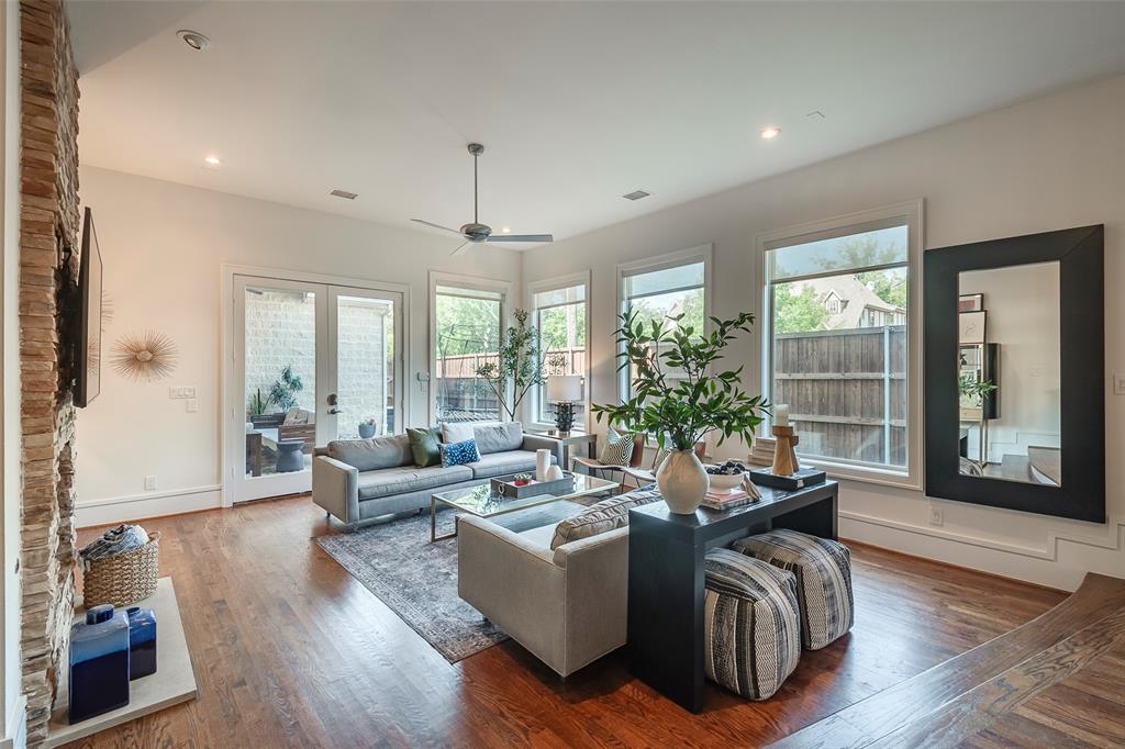 a living room with furniture and large windows