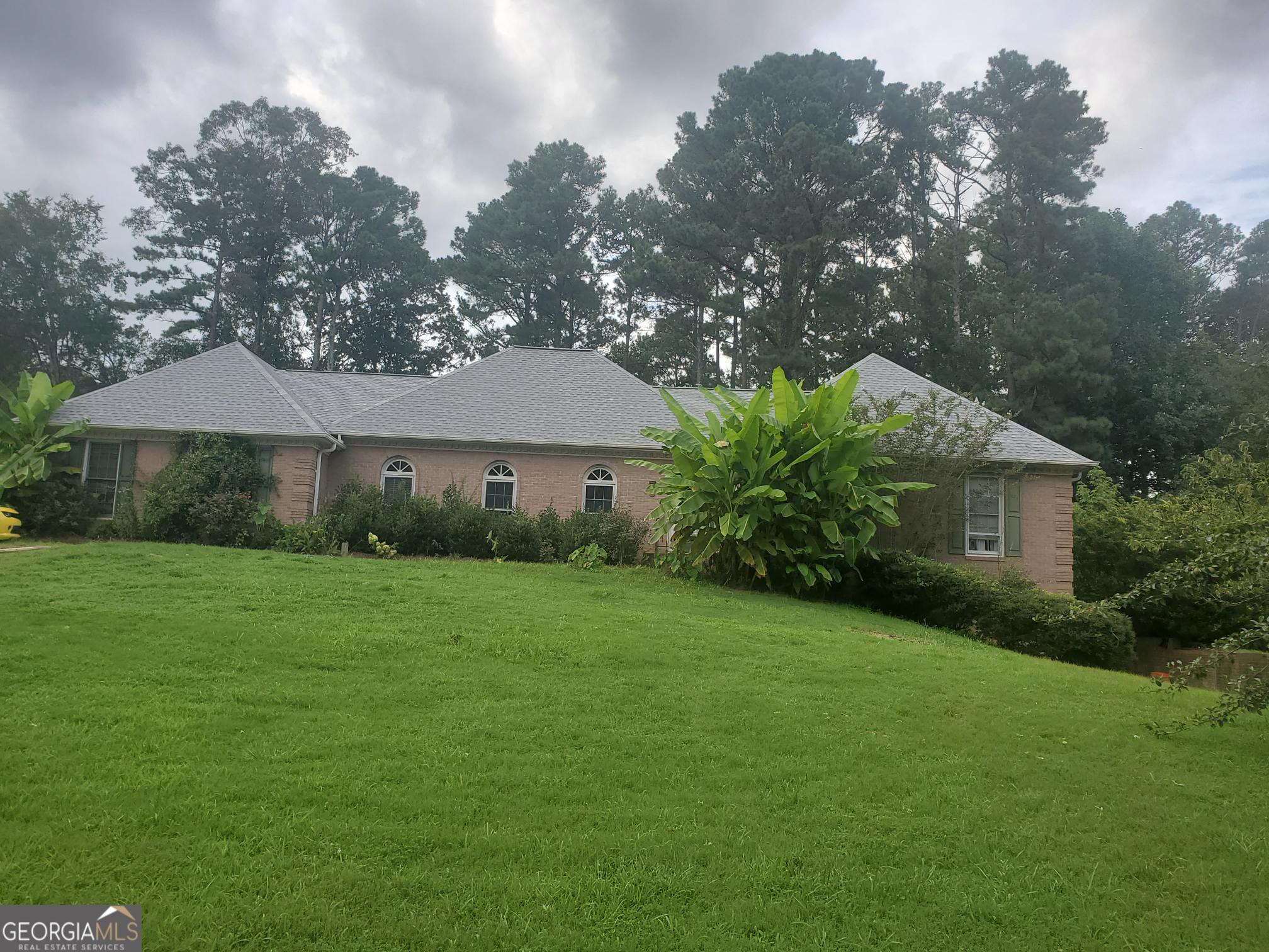 a front view of a house with garden