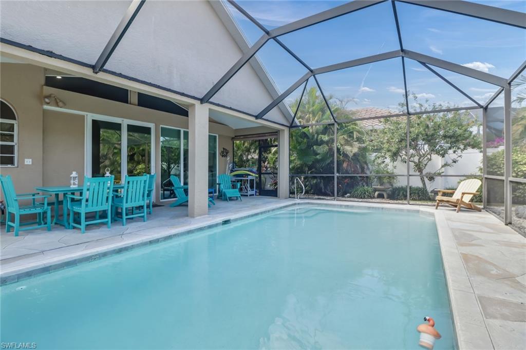 a view of a patio with table and chairs under an umbrella