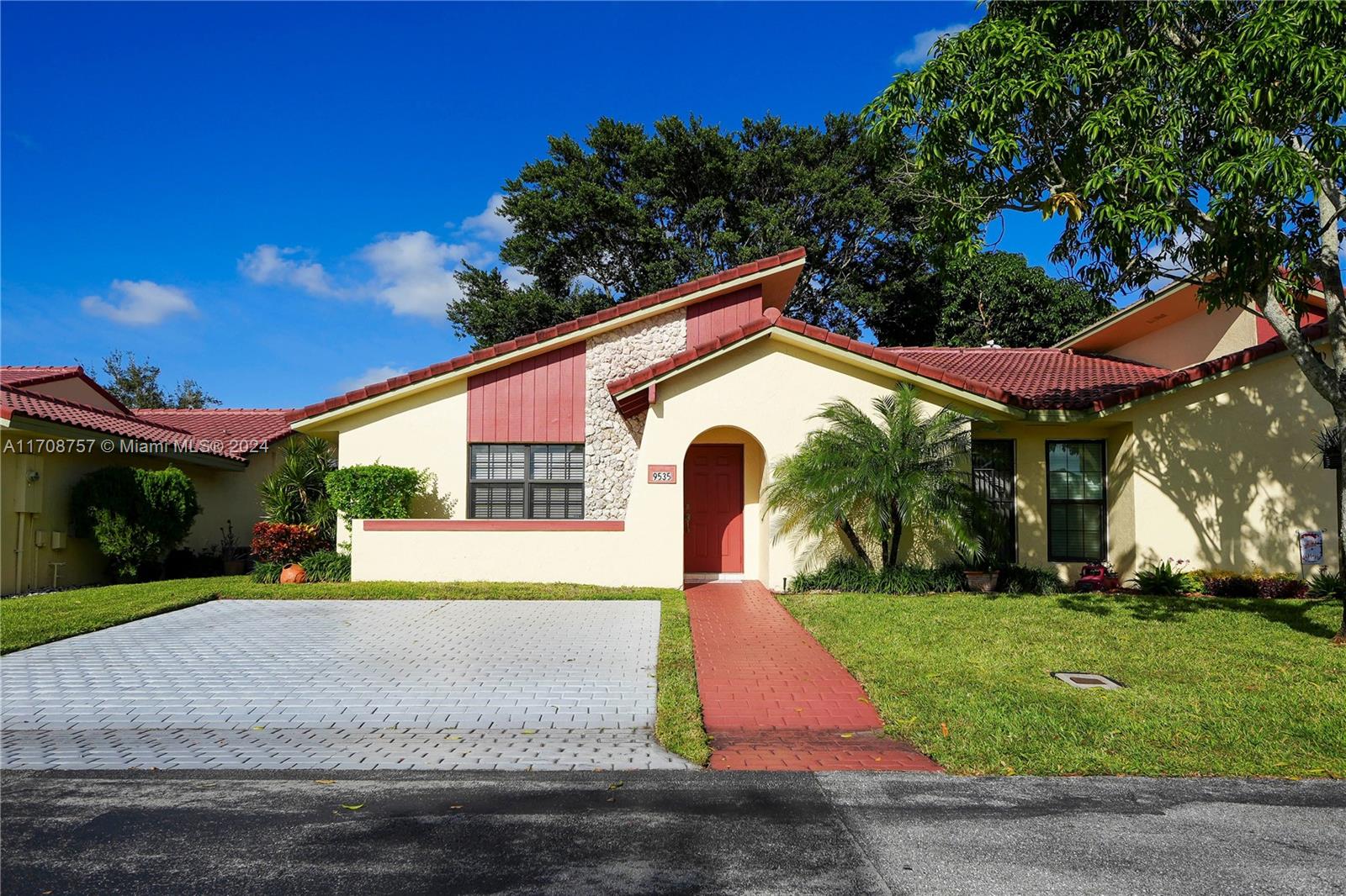 a front view of house with yard and green space