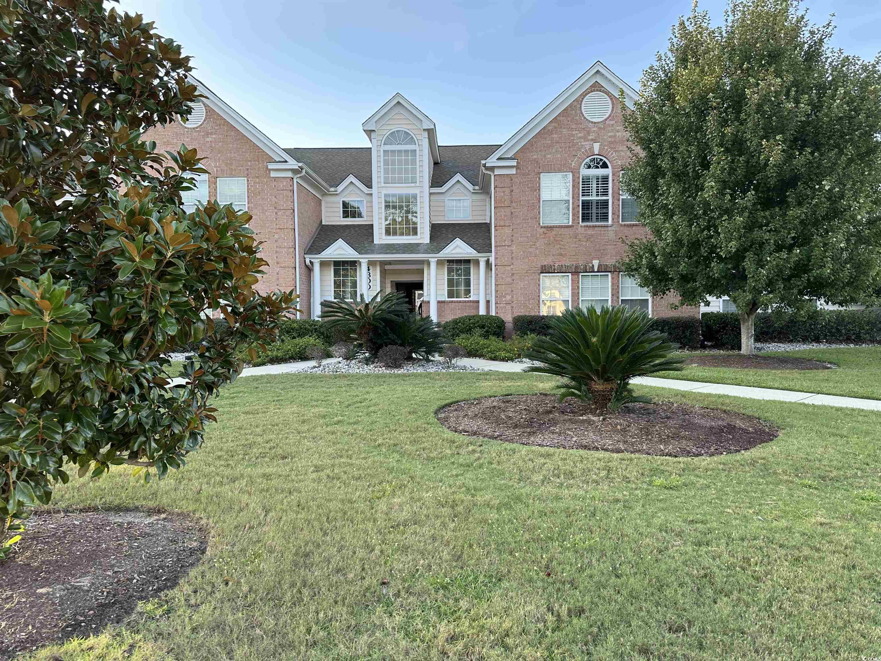 Front facade featuring a front lawn