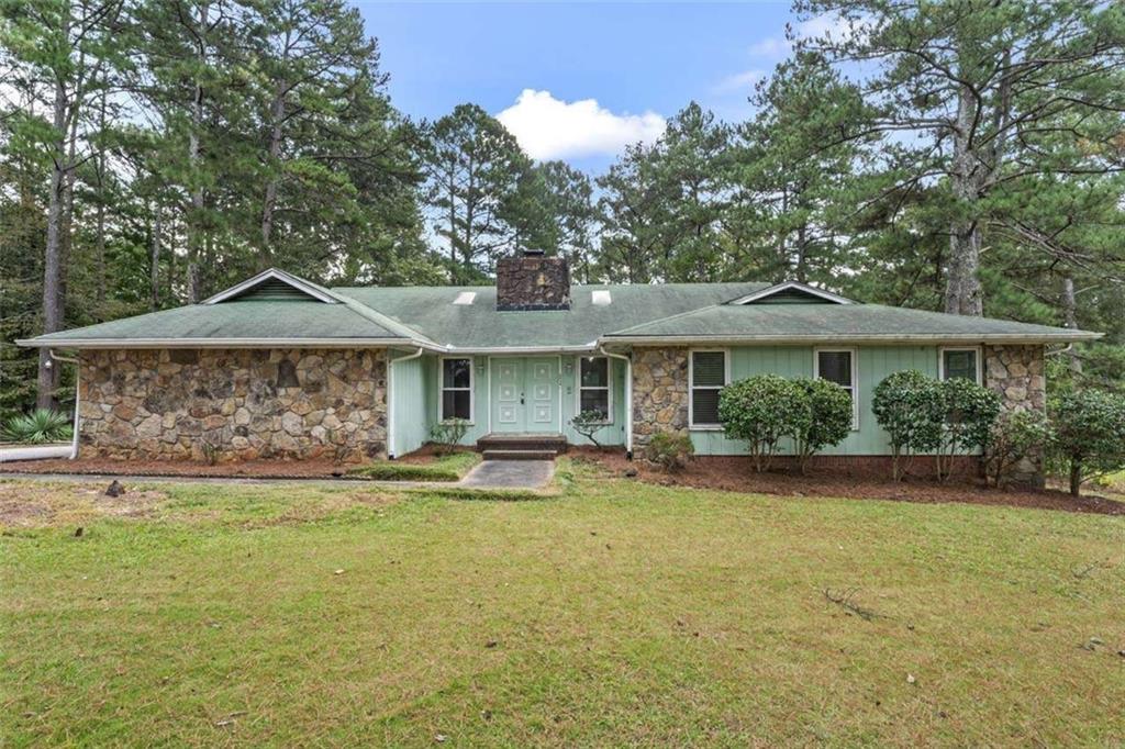 a front view of a house with a garden and patio