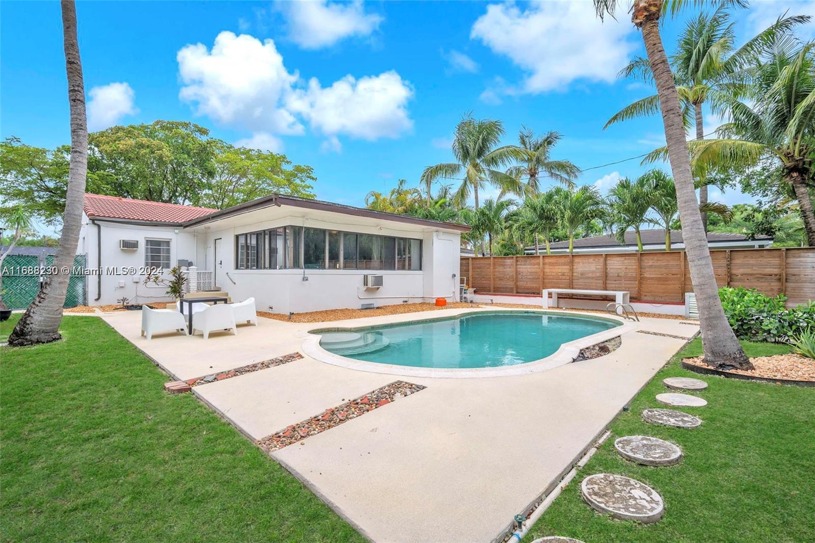 a swimming pool with outdoor seating and yard