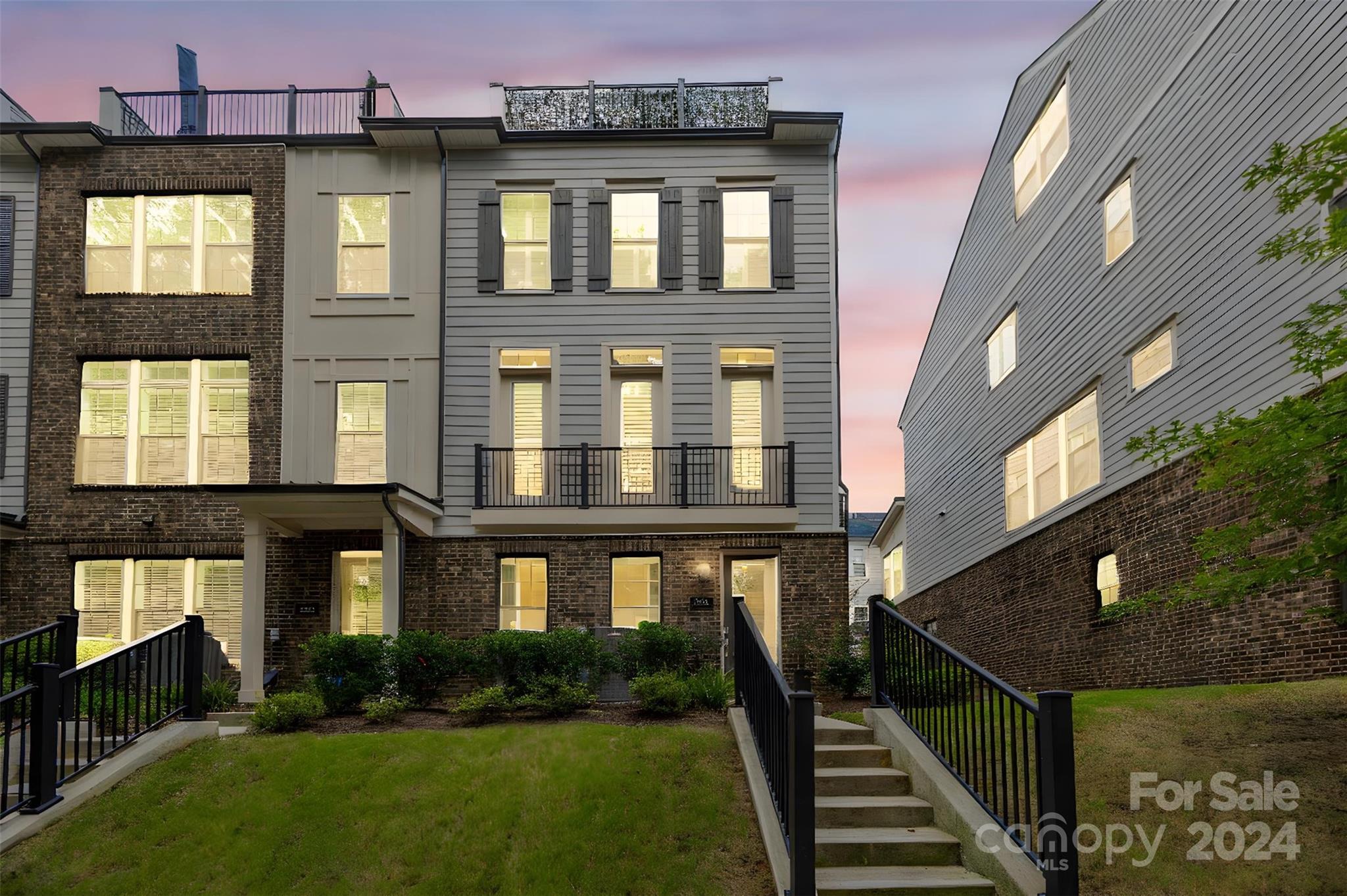 a front view of a residential apartment building with a yard