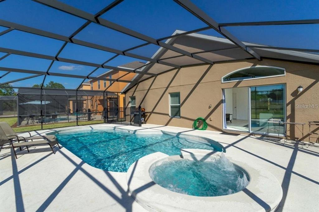 a view of a backyard with sitting area