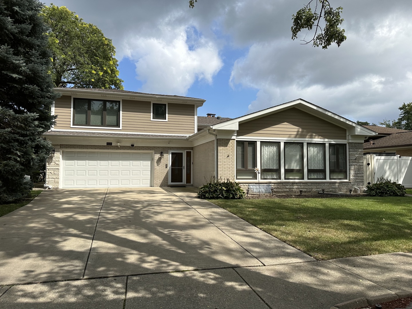 a front view of a house with a garden