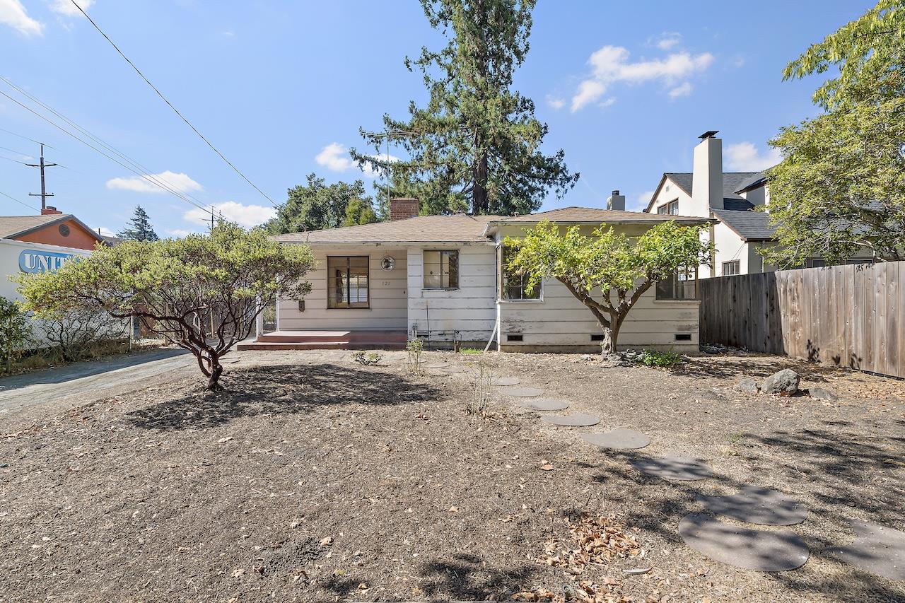 a view of a house with a yard and garage