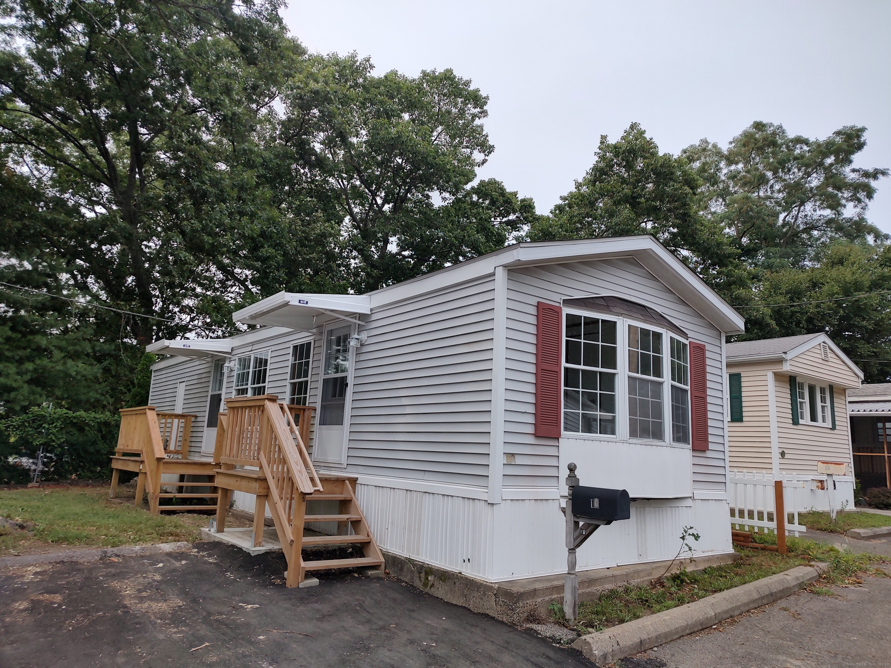 a view of a house with a yard and deck