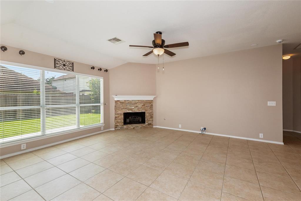 a view of an empty room with a fireplace