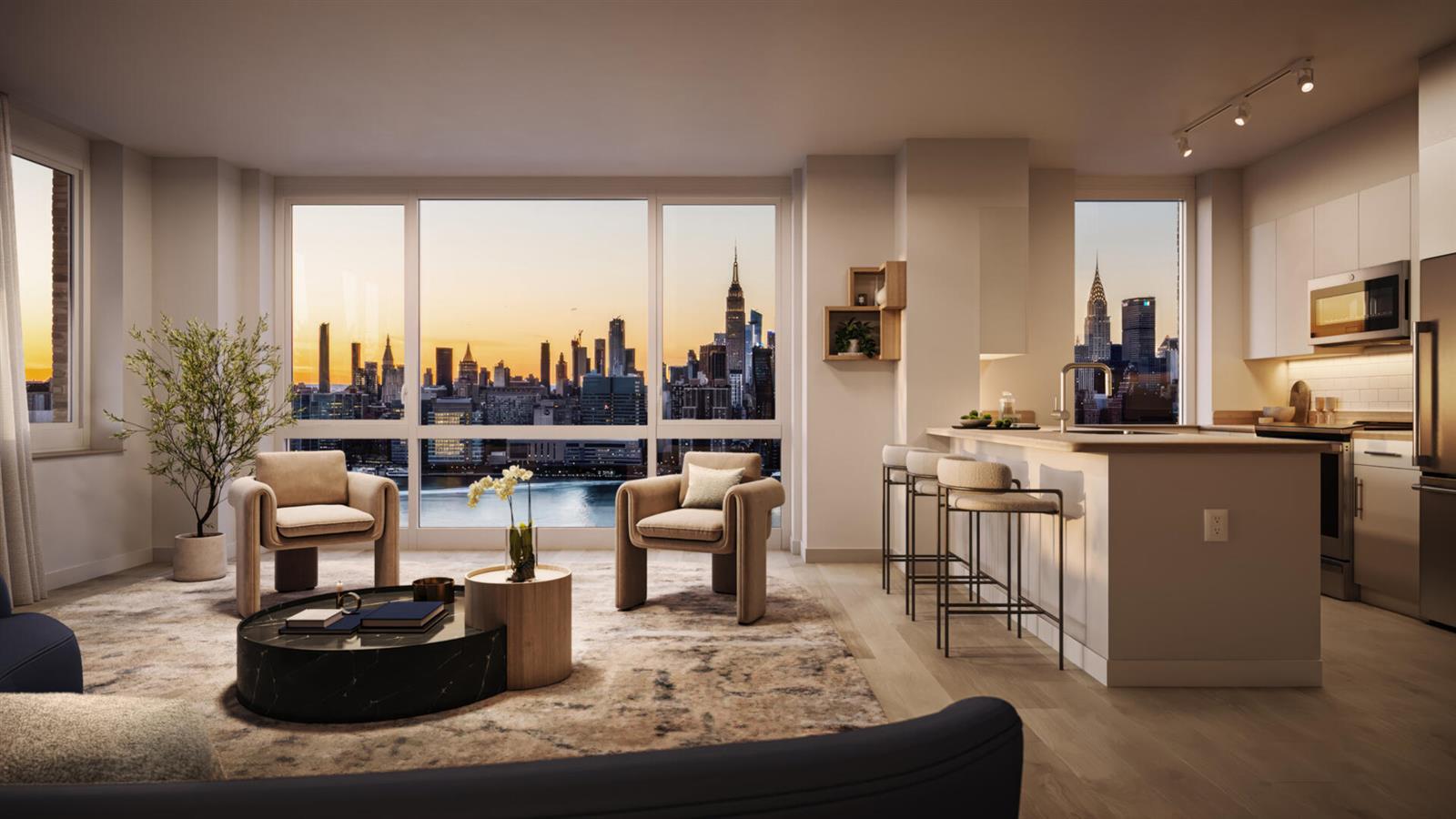 a living room with couches and a kitchen view