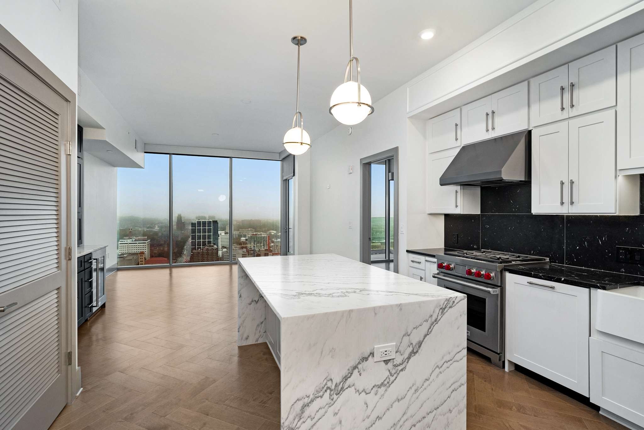 a kitchen with stainless steel appliances a stove a sink and a refrigerator