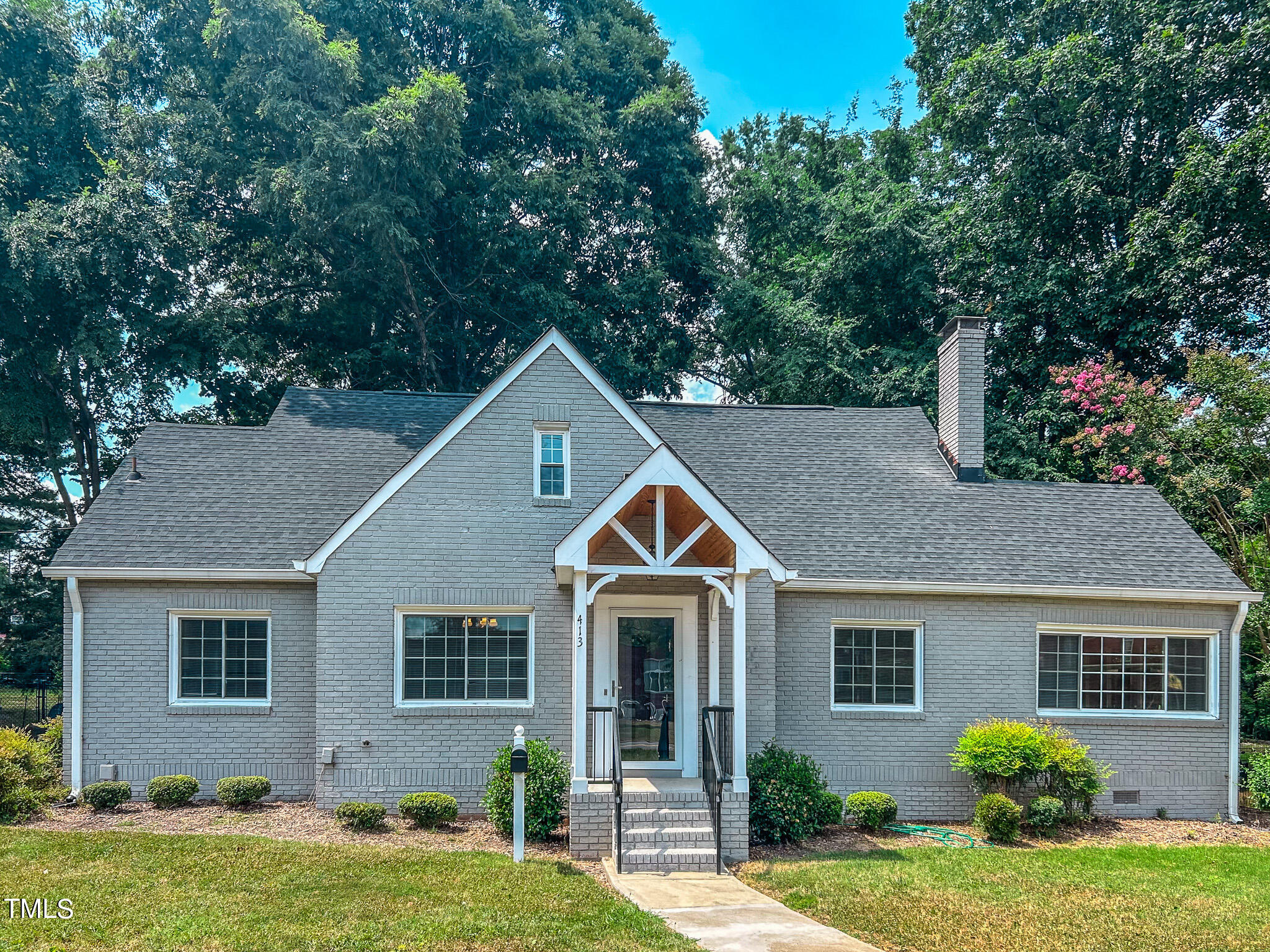 a front view of house with yard and green space