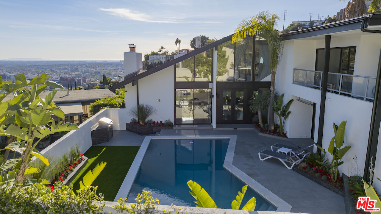 swimming pool view with a outdoor seating