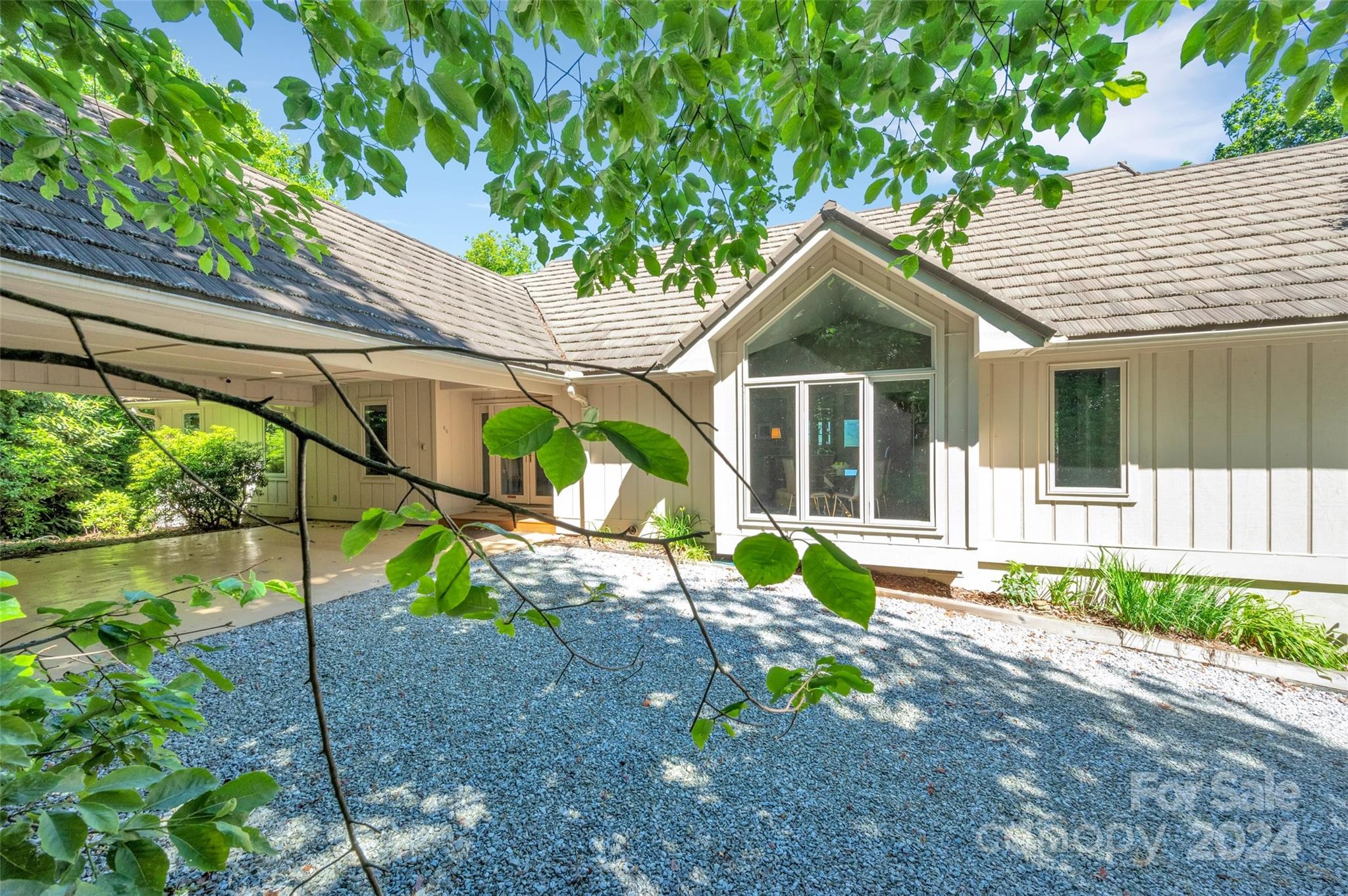 a view of a house with a yard and a garden